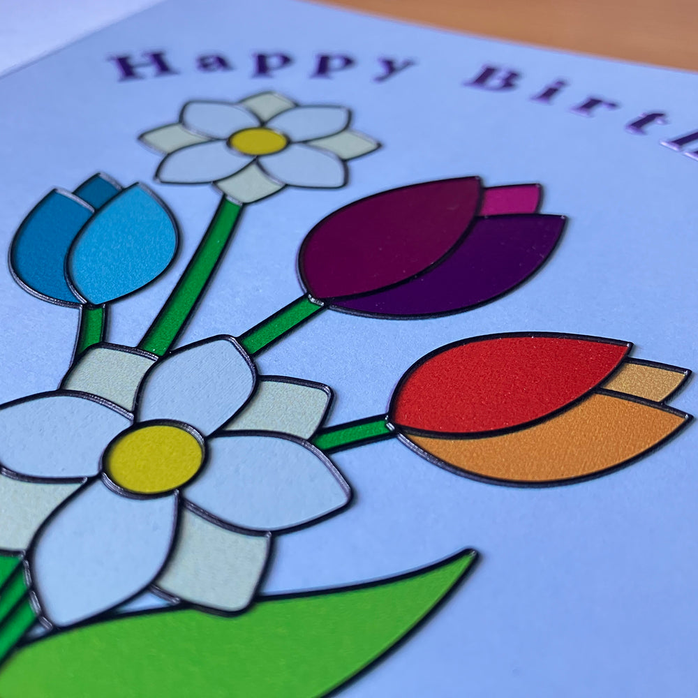 Colorful flower tactile illustration on a birthday card with 'Happy Birthday' text.