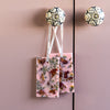 Two wax tablets with visible ingredients hanging on a pink cabinet door.