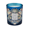 Decorative candle with a blue glass container and intricate floral design.