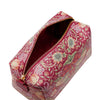 Floral patterned toiletry bag with gold zipper on a white background
