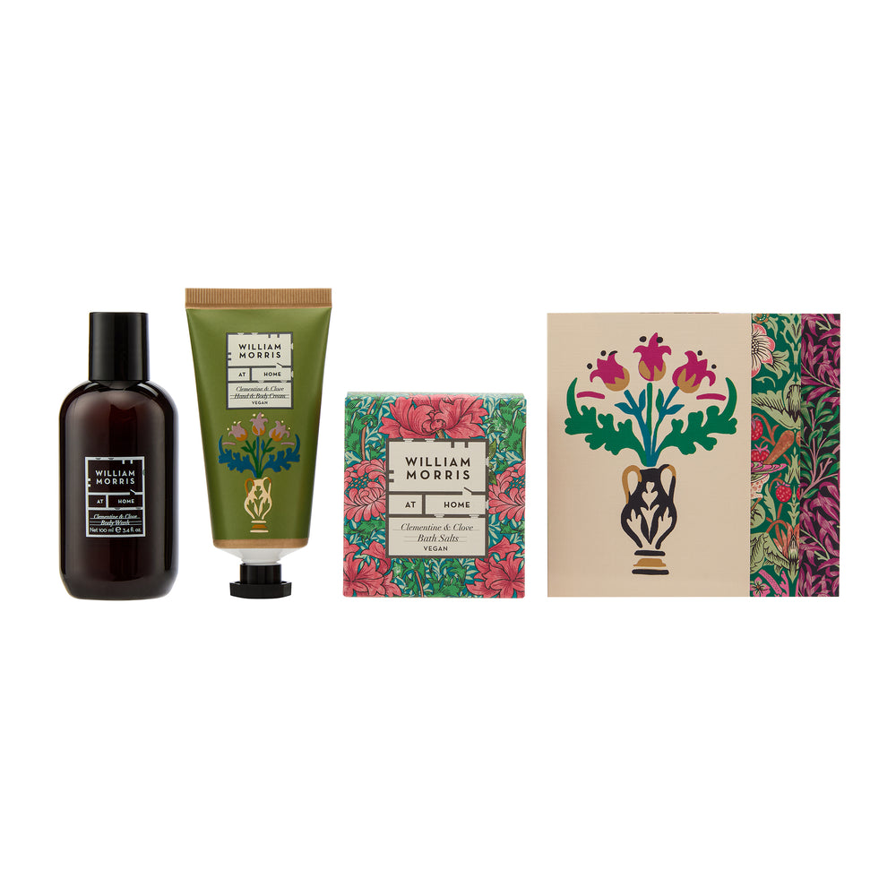 Collection of William Morris beauty products including a bottle, tube, and boxes with floral designs on a white background.