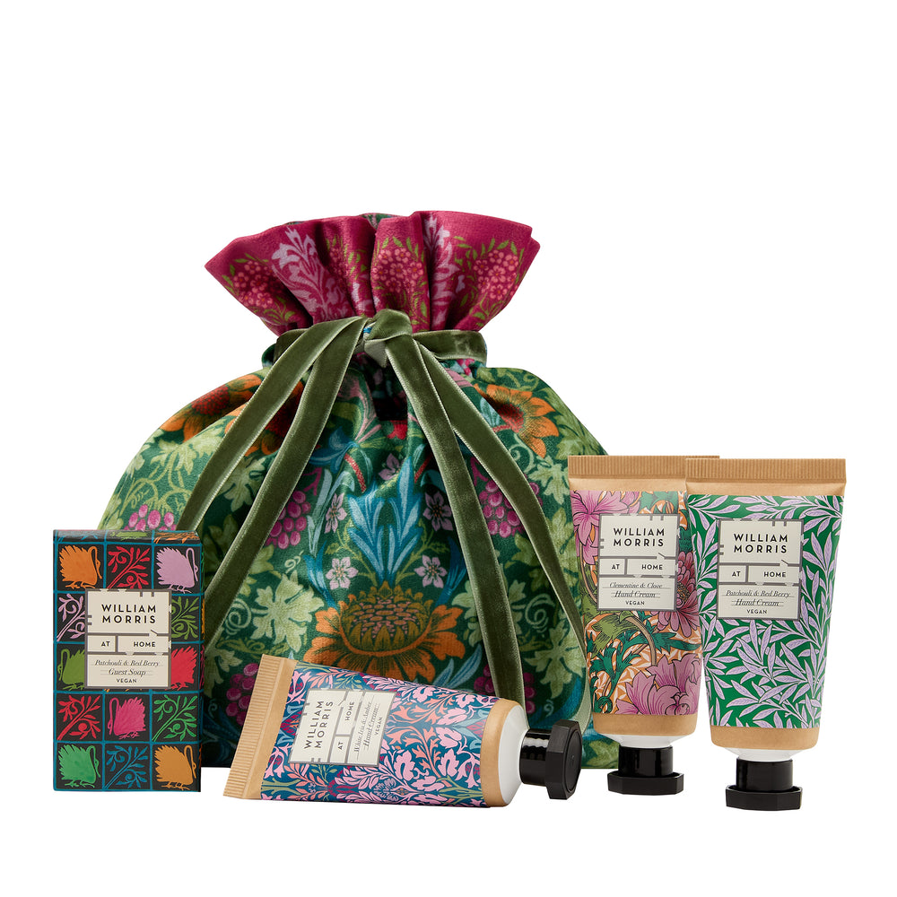 Set of William Morris-themed products including a drawstring bag, soap, and hand cream on a white background.