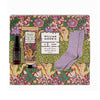 Gift set with body cream, pillow mist, and socks on a decorative box with floral design.