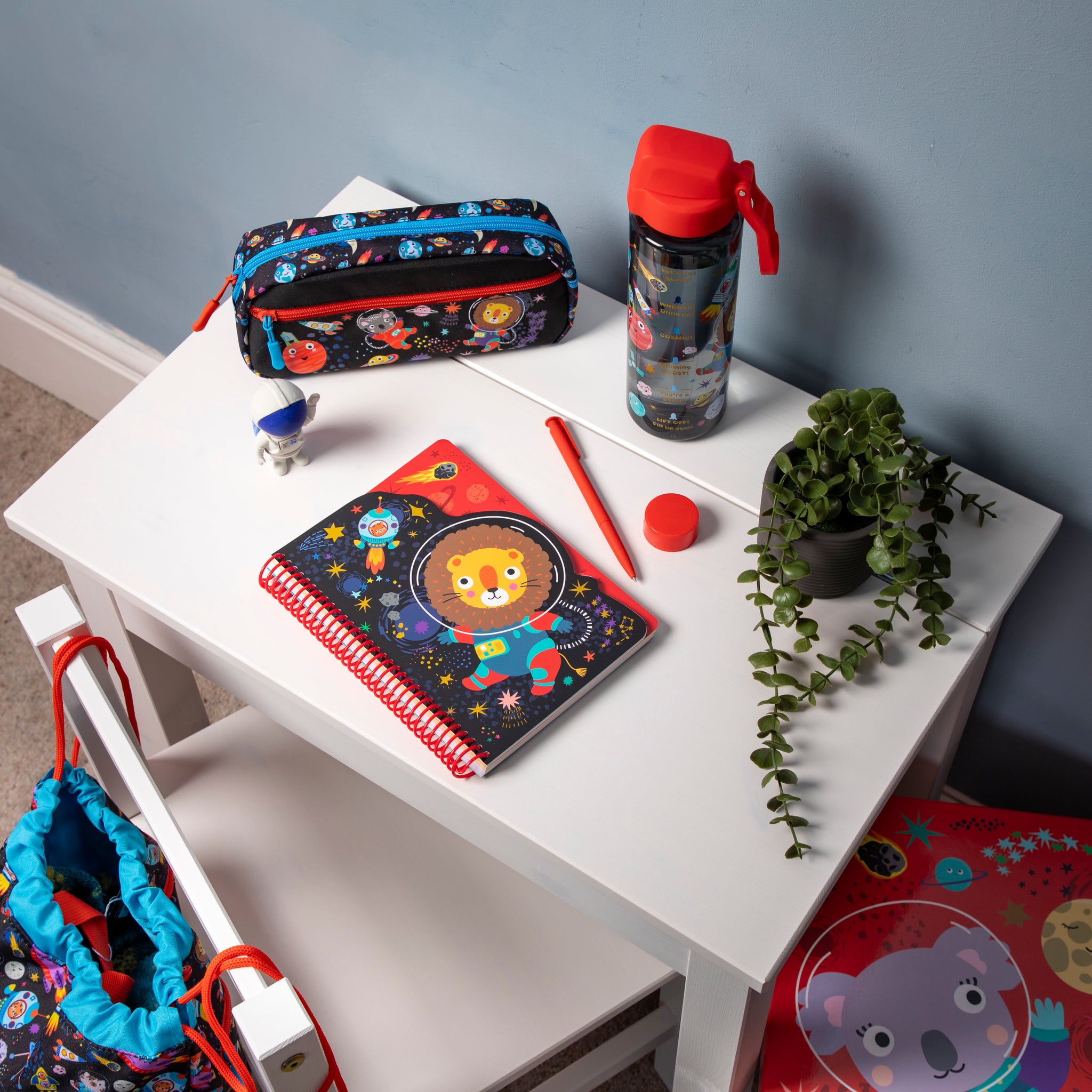 Space themed notepad on a child's desk.