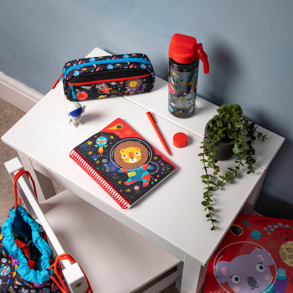 Space themed notepad on a child's desk.