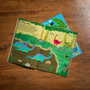 Children's dinosaur-themed activity book on a wooden surface