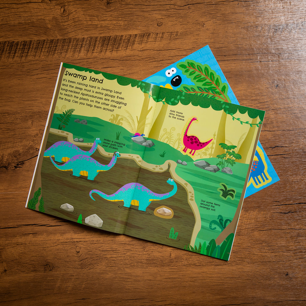 Children's dinosaur-themed activity book on a wooden surface