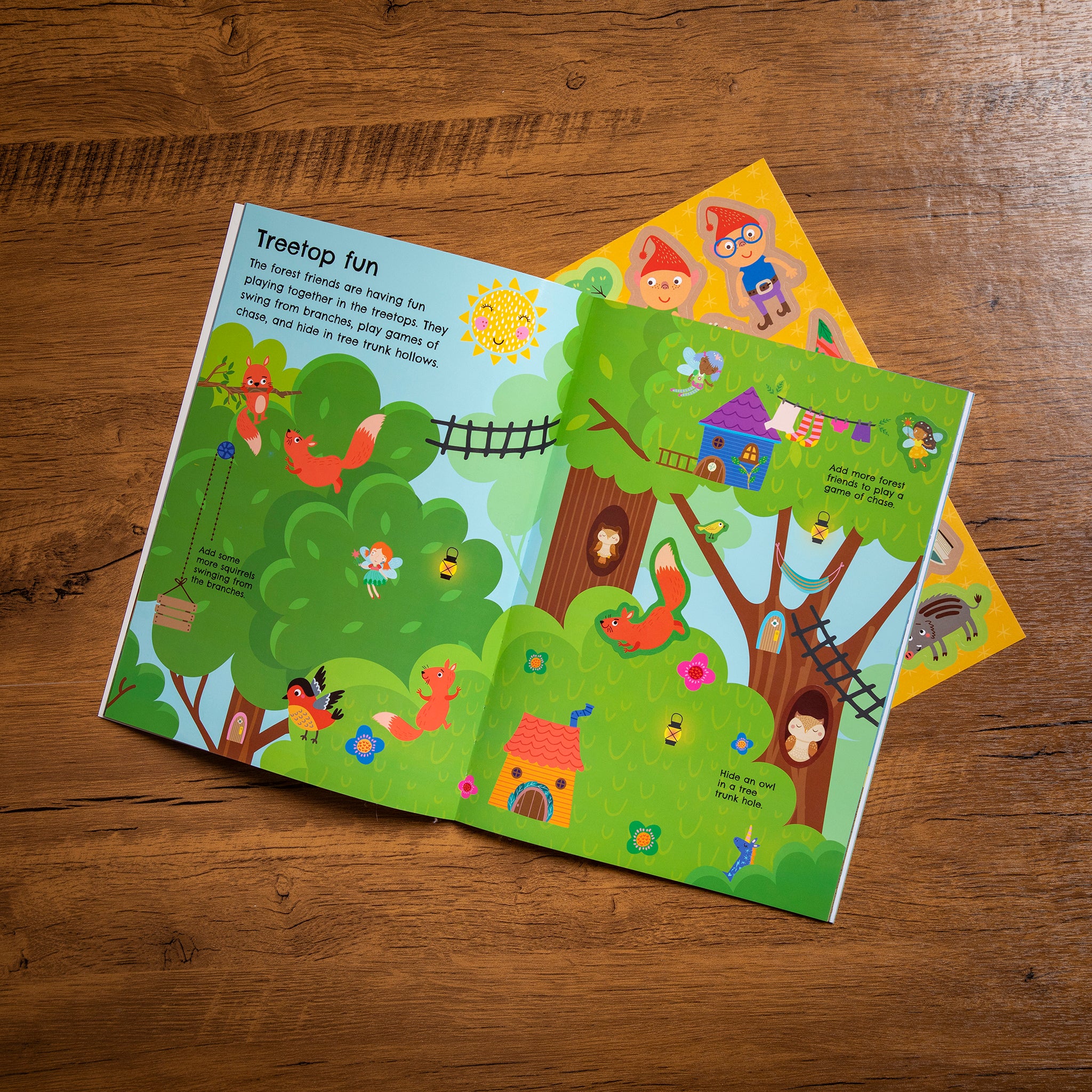 Children's book with a treehouse illustration on a wooden surface