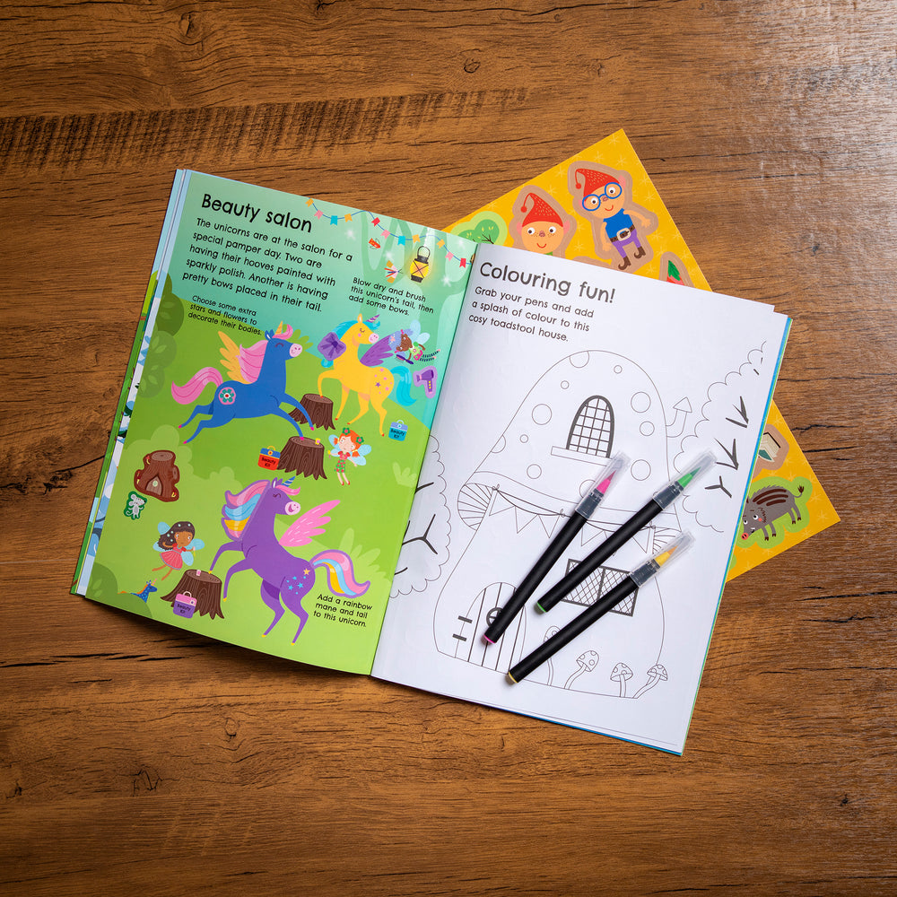 Coloring book with a coloring page and markers on a wooden surface