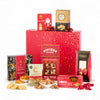 Assorted food products including cookies, sweets, and snacks displayed in front of a red gift box.