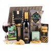 Wine gift basket with Bottega Cabernet Sauvignon, snacks, and a glass of red wine.