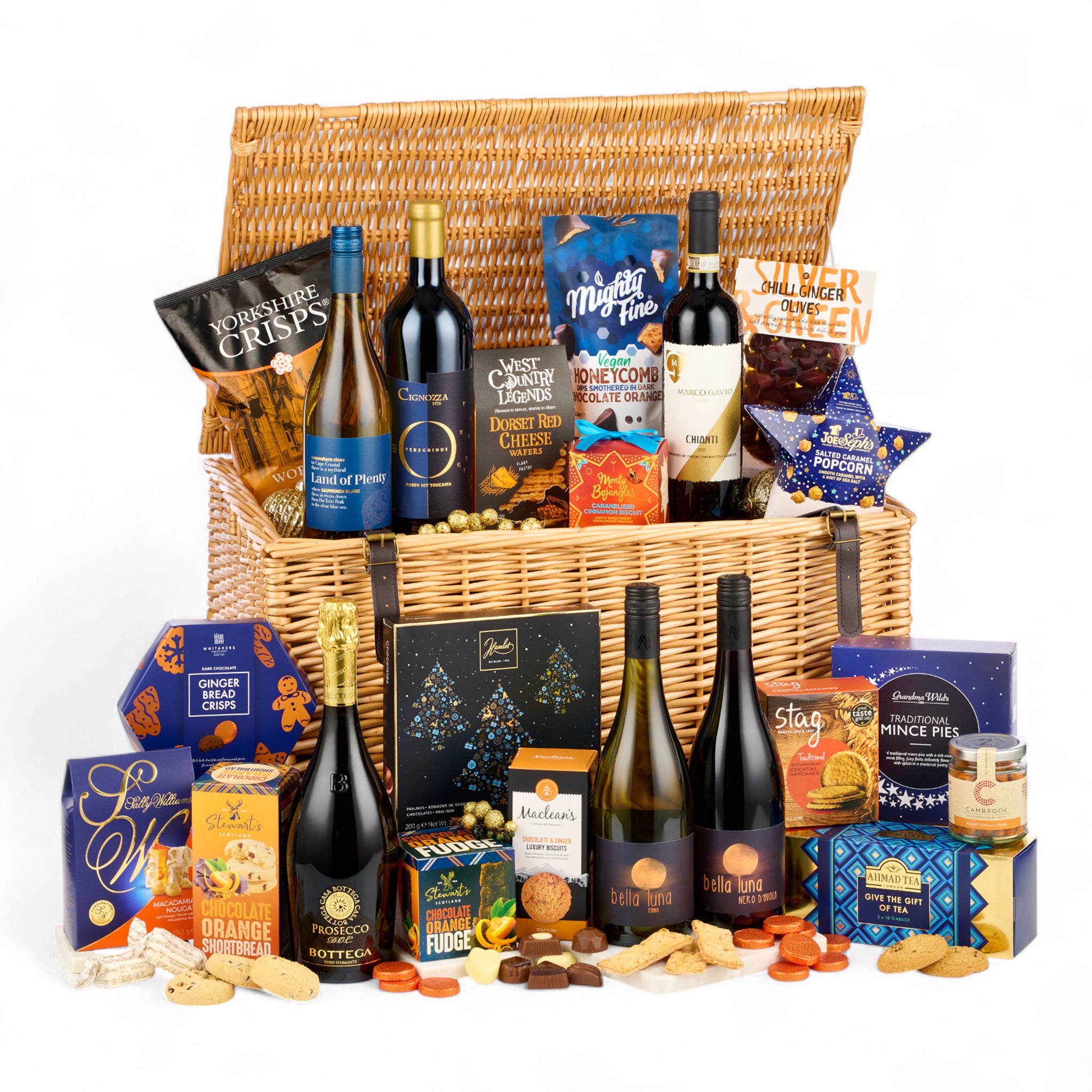 Wicker hamper filled with various snacks, cheeses, and bottles of wine on a white background
