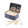 Wooden bird feeder building set with components and a blue tin box on a white background