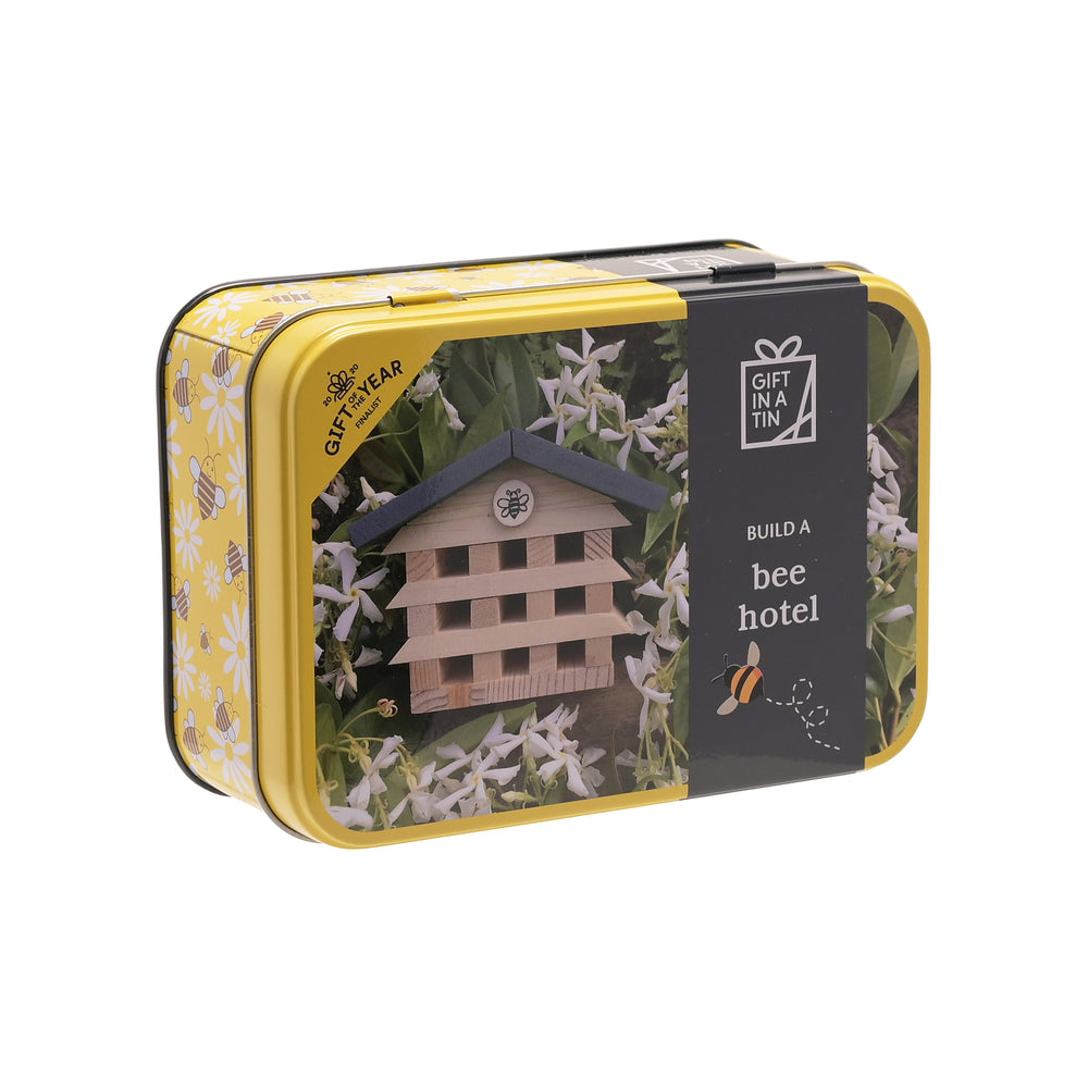 Yellow tin box with a bee hotel design on a white background