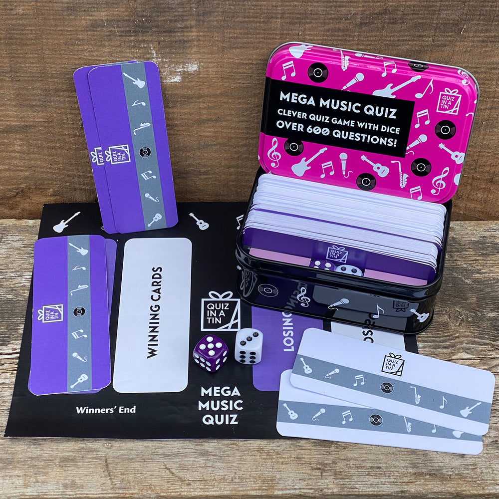 Mega Music Quiz game set with cards and dice on a wooden surface
