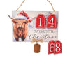 Christmas countdown sign with a cow wearing a Santa hat and red tags displaying numbers.