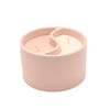 Pink candle holder with a candle inside on a white background