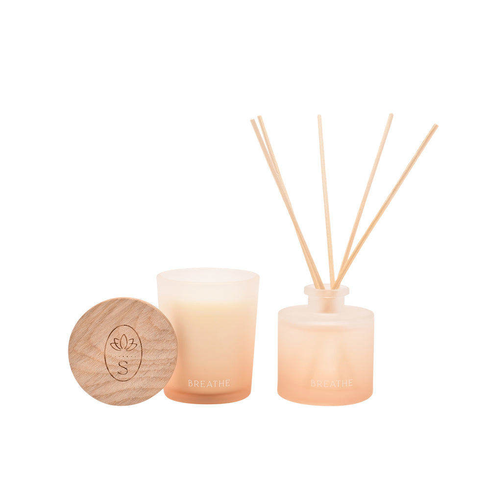 Candle, diffuser, and wooden coaster with a brand logo on a white background