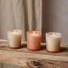 Three candles labeled 'Balance', 'Flow', and 'Breathe' on a wooden surface with a neutral background.