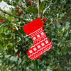 Red and white Christmas stocking tree decoration hanging on a tree. 