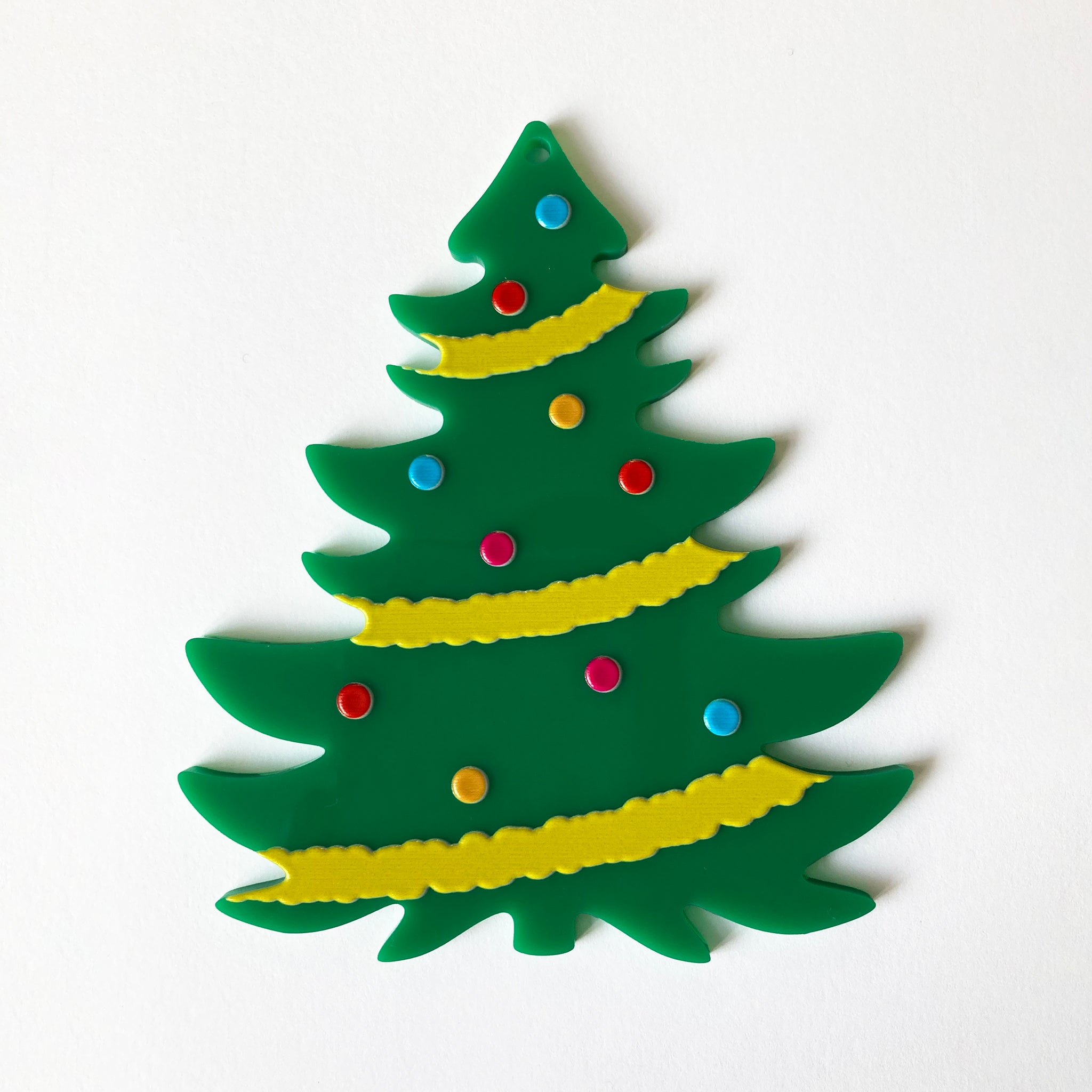 Decorative Christmas tree ornament with colorful dots on a white background