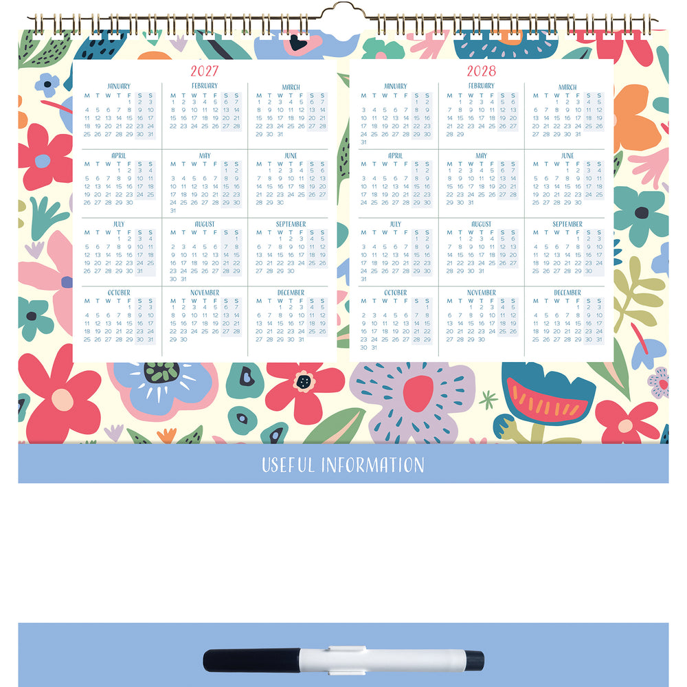 A spiral-bound desk calendar page with a colorful floral border and two yearly calendar grids for 2027 and 2028. A blue banner near the bottom reads 'USEFUL INFORMATION,' and a black-and-white marker is shown below on a light blue surface.