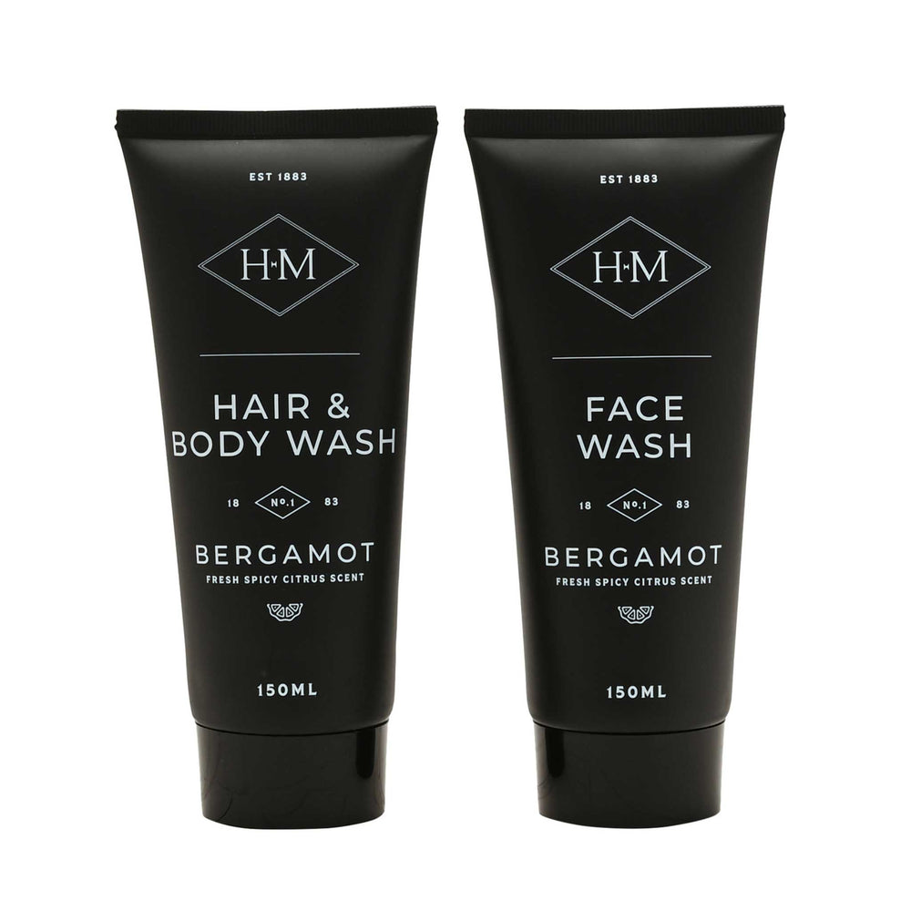Two black tube packaging of hair and body wash and face wash with Bergamot scent on a white background.