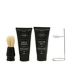 Set of black grooming products with brush and stand on a white background