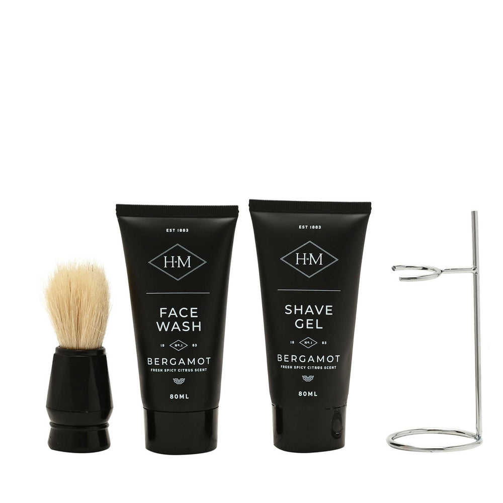 Set of black grooming products with brush and stand on a white background