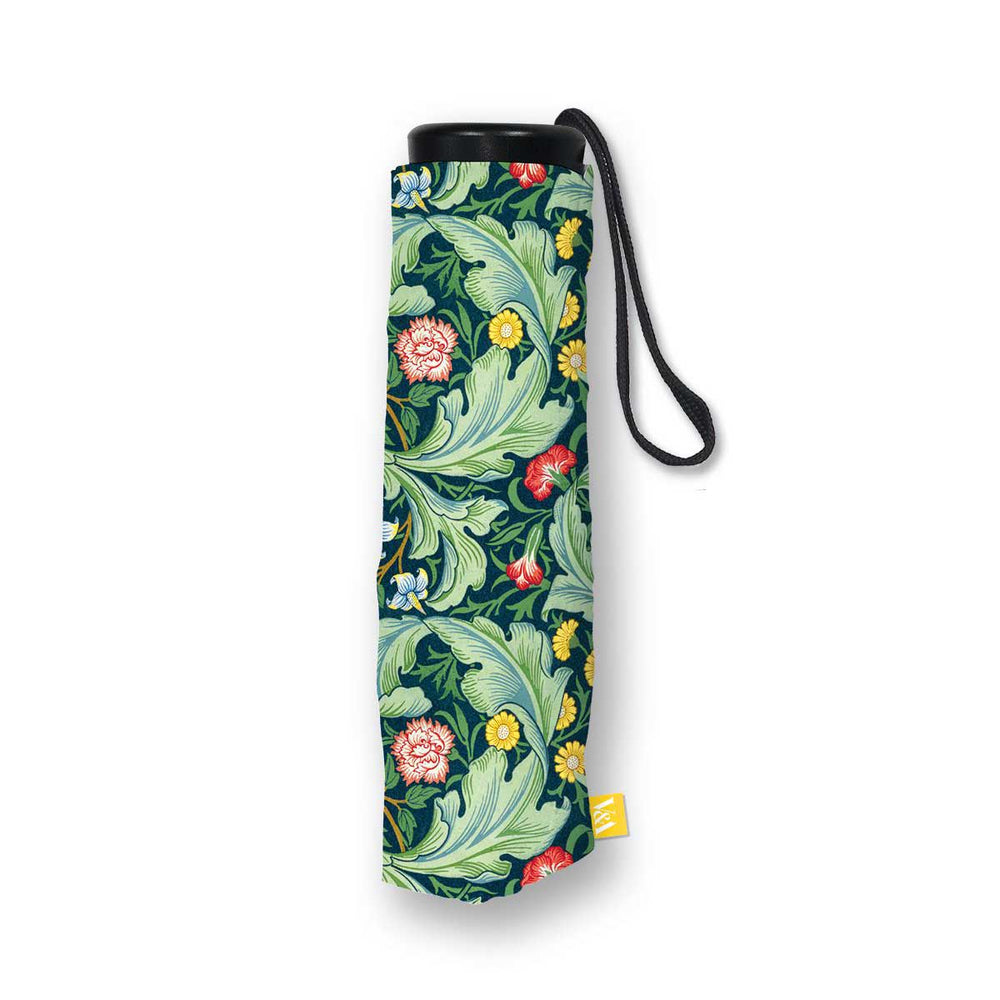A rolled-up folding umbrella with a black wrist strap, featuring a classic green and blue botanical pattern with pink and yellow flowers, shown on a white background.