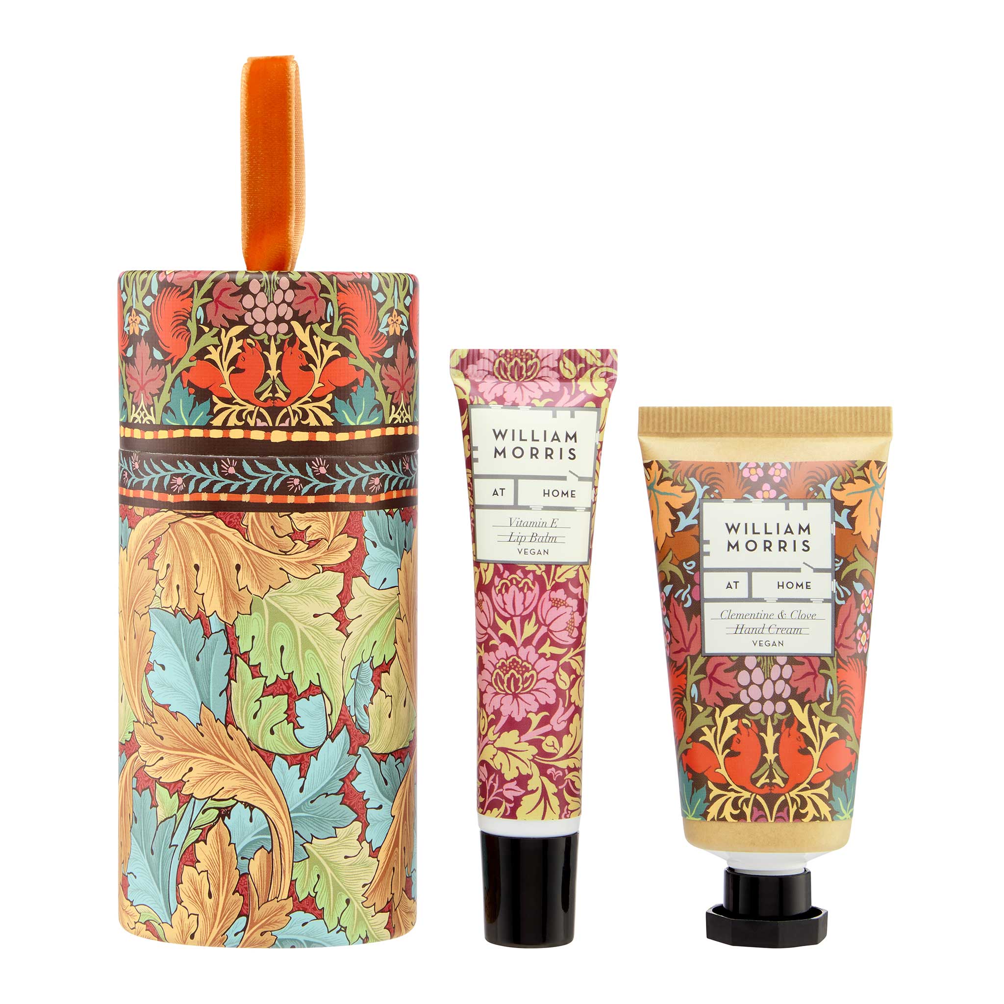 William Morris 'Pomegranate & Fig Butter' hand cream and hand wash gift set, featuring a cylindrical box with a handle, a squeeze tube, and a squeeze bottle, all decorated with a colorful William Morris pattern of pomegranates and fig leaves, on a white background.