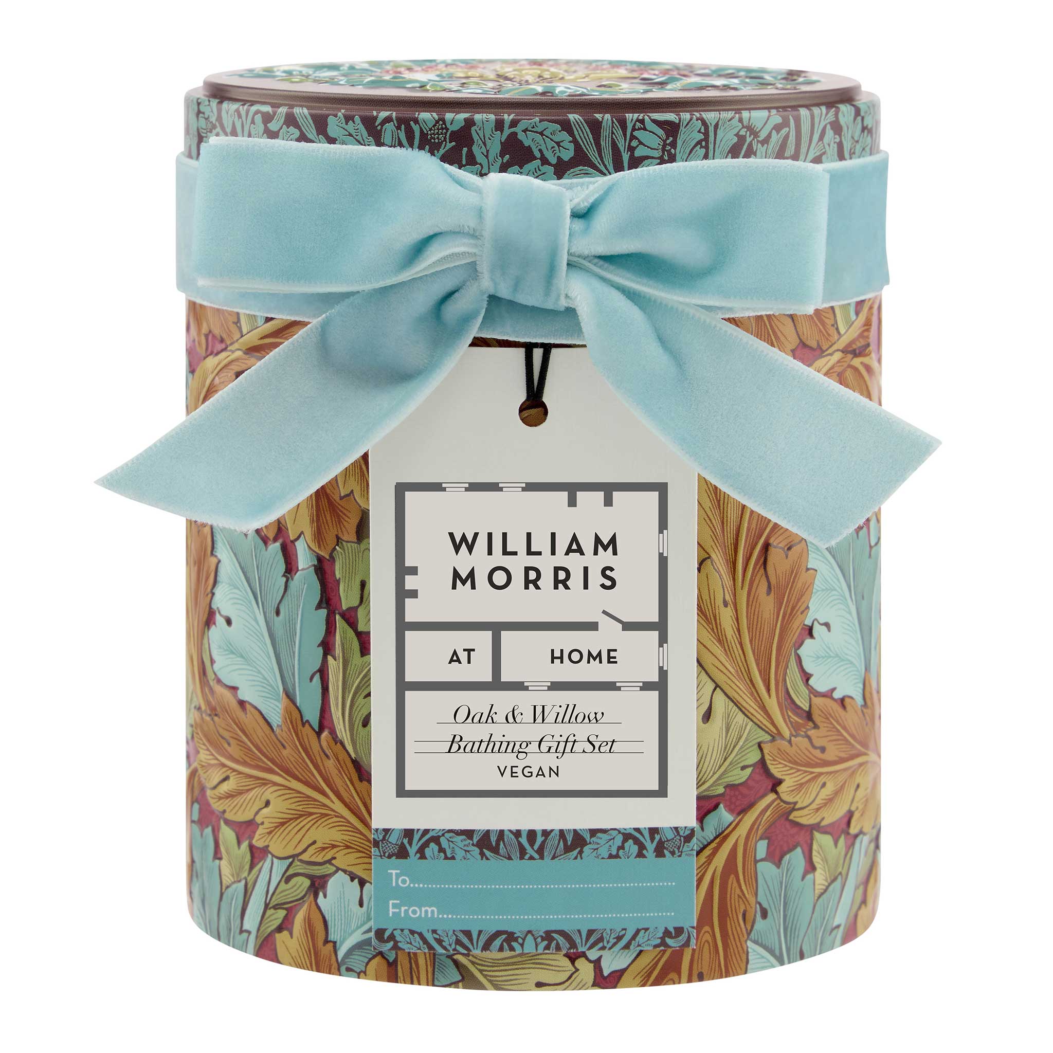William Morris At Home Bathing Gift Set in a cylindrical tin with a floral pattern, tied with a light blue velvet bow and featuring a white gift tag.