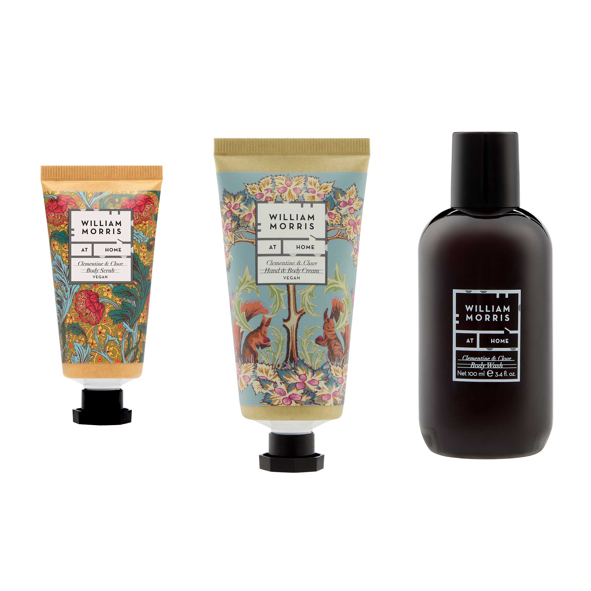 Three William Morris No. 9000 hand and body care products on a white background: a small pink and gold lotion tube, a larger blue and gold hand cream tube with a tree motif, and a dark brown bottle with a black cap.