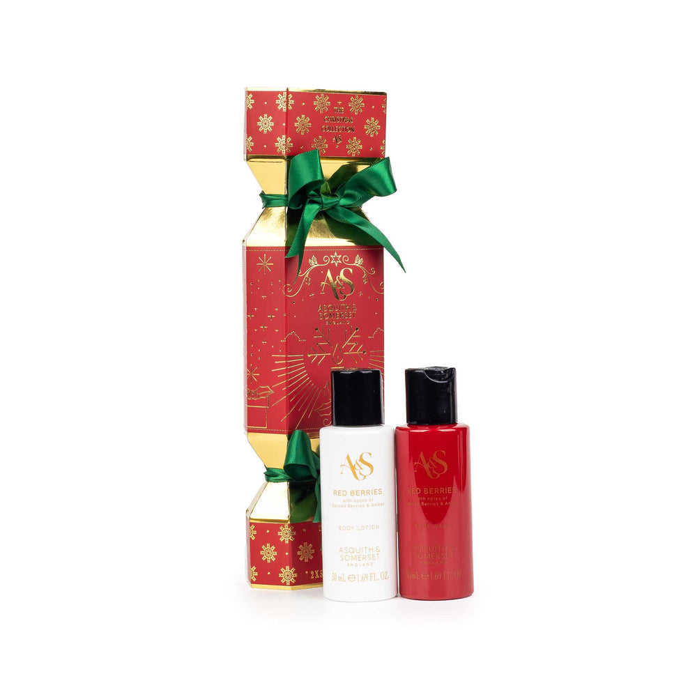 AS in Style Christmas gift set featuring a red and gold Christmas nutcracker box with a green ribbon, alongside two bottles: a white bottle of Red Remedy hand sanitizer and a red bottle of Passion Fruit hand sanitizer.