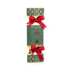 A Christmas-themed cylindrical box with a green and gold patterned design, tied with two red satin bows, on a plain white background.