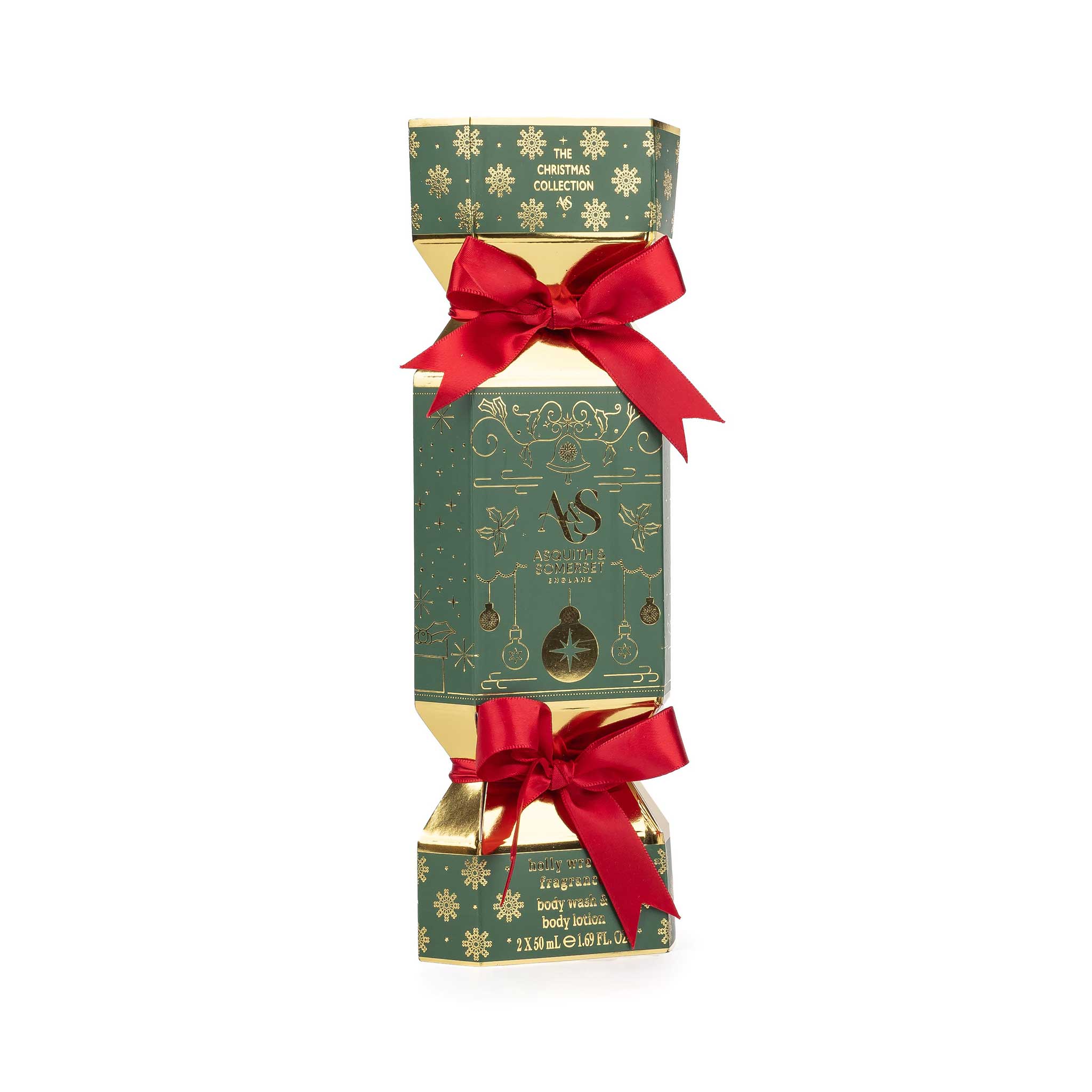 A Christmas-themed cylindrical box with a green and gold patterned design, tied with two red satin bows, on a plain white background.