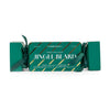 A Christmas-themed gift set of 'Jingle Beard' beard oil and beard wash by The Somberly Toilet Co. The product is packaged in a green Christmas cracker box with a dark green ribbon bow, featuring gold diagonal stripes and white text on a clean white background.