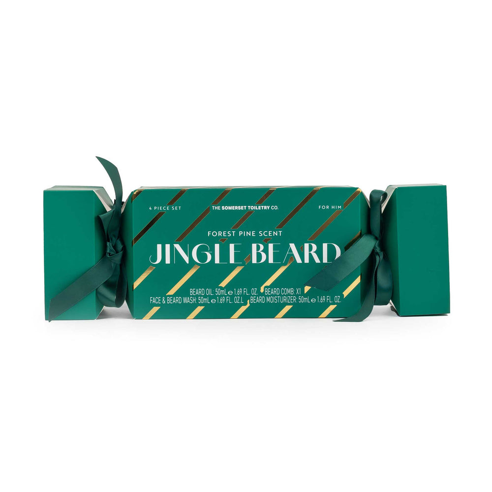A Christmas-themed gift set of 'Jingle Beard' beard oil and beard wash by The Somberly Toilet Co. The product is packaged in a green Christmas cracker box with a dark green ribbon bow, featuring gold diagonal stripes and white text on a clean white background.