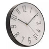 A modern round wall clock with a glossy black frame and hands, featuring minimalist black numerals on a white face, shown against a plain white background.