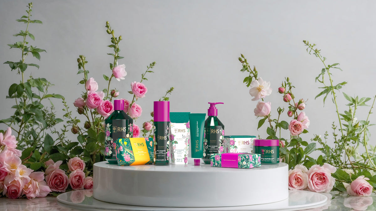 RHS toiletries in front of pink roses and decorative greenery
