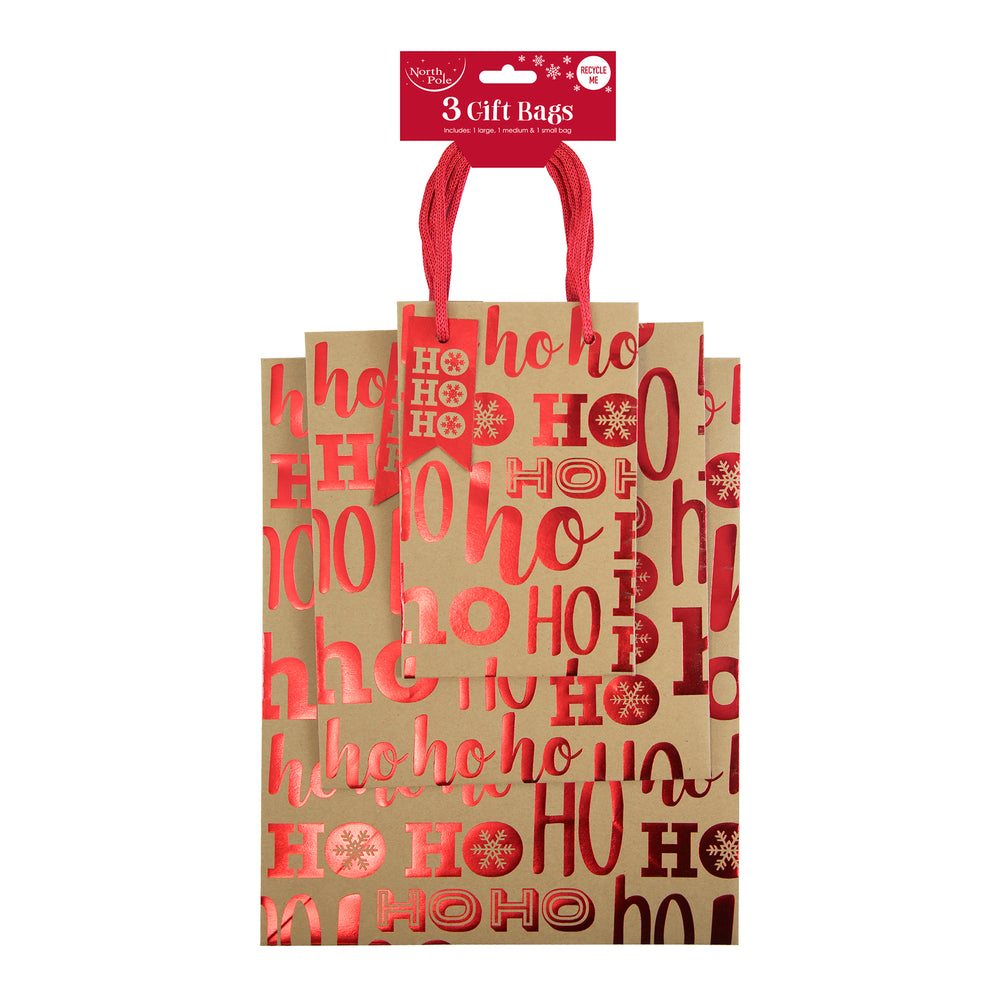 Set of three Christmas gift bags with 'HO HO HO' text on a white background