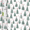 A roll of gift wrap with a repeating pattern of green pine trees and small red stars on a white background, shown next to the wrapped core of the roll.